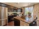 Modern kitchen with dark cabinetry, stainless steel appliances, and a center island with bar seating at 7312 Grady Cir, Castle Rock, CO 80108