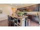 Kitchen with an island, granite countertops, dark cabinets and hardwood floors at 7312 Grady Cir, Castle Rock, CO 80108