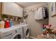 Laundry room features a front load washer/dryer and upper storage at 7312 Grady Cir, Castle Rock, CO 80108