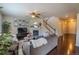 Cozy living room with a fireplace, ceiling fan, and staircase at 7312 Grady Cir, Castle Rock, CO 80108