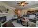 Inviting living room with a fireplace, ceiling fan, hardwood floors and stairs to the second level at 7312 Grady Cir, Castle Rock, CO 80108