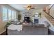 Cozy living room with a fireplace, large windows and hardwood floors creating a warm atmosphere at 7312 Grady Cir, Castle Rock, CO 80108