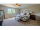 Comfortable main bedroom with neutral decor, large window, and a ceiling fan at 7312 Grady Cir, Castle Rock, CO 80108