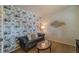Comfortable office with floral wallpaper, sofa, work desk, and natural light at 7312 Grady Cir, Castle Rock, CO 80108