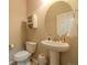 Half bathroom with a pedestal sink, toilet, and storage cabinet at 7312 Grady Cir, Castle Rock, CO 80108