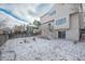 Backyard with a patio and upper balcony, snow covered yard, and wooden fence around the perimeter at 10510 Berthoud Way, Parker, CO 80134