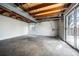 Unfinished basement with concrete floors, a sliding door and a window to let in natural light at 10510 Berthoud Way, Parker, CO 80134