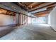 Unfinished basement space featuring exposed ceiling beams and concrete flooring at 10510 Berthoud Way, Parker, CO 80134