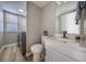 Bathroom and laundry room features white cabinets, a marble countertop, and a modern toilet at 10510 Berthoud Way, Parker, CO 80134