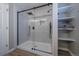 Modern shower area with glass enclosure, matte black fixtures, and shelving at 10510 Berthoud Way, Parker, CO 80134