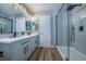 Modern bathroom features gray cabinets, sleek fixtures, and a glass-enclosed shower at 10510 Berthoud Way, Parker, CO 80134