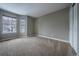 Bright bedroom with two large windows and neutral-colored walls and carpet at 10510 Berthoud Way, Parker, CO 80134