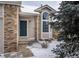 Home entrance with a dark blue door, brick accents, and a large window for ample natural light at 10510 Berthoud Way, Parker, CO 80134