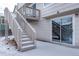 Exterior view of the home, showing access to the deck from the patio area, complemented by a sliding glass door at 10510 Berthoud Way, Parker, CO 80134