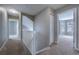 Upstairs hallway with carpet, white railing, and access to bedrooms at 10510 Berthoud Way, Parker, CO 80134