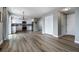 Open kitchen features white cabinets, stainless steel appliances, modern lighting, and a gray backsplash at 10510 Berthoud Way, Parker, CO 80134