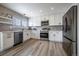 Well-lit kitchen with stainless steel appliances, white cabinetry and modern backsplash at 10510 Berthoud Way, Parker, CO 80134