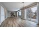 Bright living room featuring a fireplace, wood floors, modern lighting, and access to a balcony at 10510 Berthoud Way, Parker, CO 80134