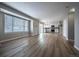 Spacious living room with wood floors, a modern light fixture, and an open concept kitchen at 10510 Berthoud Way, Parker, CO 80134