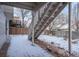 Exterior patio view featuring snow covered patio, stone accents, and backyard at 10510 Berthoud Way, Parker, CO 80134