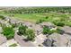 An aerial view of several tan homes alongside a lush golf course on a sunny day at 12912 Grant Cir # A, Thornton, CO 80241