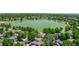 An aerial view of homes nestled near a serene lake and surrounded by lush green trees at 12912 Grant Cir # A, Thornton, CO 80241