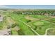 Gorgeous aerial view of a lush green golf course surrounded by many homes in the distance at 12912 Grant Cir # A, Thornton, CO 80241