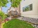 Cozy backyard with a small wooden deck, stone landscaping and a well maintained lawn at 12912 Grant Cir # A, Thornton, CO 80241