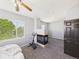 Bedroom with carpet, a fireplace, and a window offering a view of lush green trees at 12912 Grant Cir # A, Thornton, CO 80241