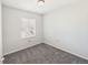Bright bedroom with window, gray walls, and neutral carpeting at 12912 Grant Cir # A, Thornton, CO 80241