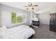 Bedroom featuring a fireplace, a bed, carpet, and natural light from a large window at 12912 Grant Cir # A, Thornton, CO 80241