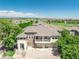 Well-maintained townhouse featuring a balcony, two-car garage, and manicured landscaping at 12912 Grant Cir # A, Thornton, CO 80241