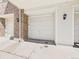 Exterior view of the property's two car garage with white door and exterior lighting at 12912 Grant Cir # A, Thornton, CO 80241