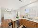 Kitchen with a stainless steel dishwasher, eat in counter space, wood cabinets, and natural light at 12912 Grant Cir # A, Thornton, CO 80241