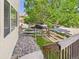 View from the deck stairs of a fenced in side yard with stone landscaping at 12912 Grant Cir # A, Thornton, CO 80241