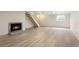 Spacious basement featuring a cozy fireplace, bright window, and easy access to the staircase at 4212 W Pondview Dr, Littleton, CO 80123