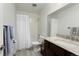 Well-lit bathroom features a shower, toilet, vanity, and large mirror at 4212 W Pondview Dr, Littleton, CO 80123