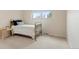 Cozy bedroom featuring natural light, window views and carpeted flooring at 4212 W Pondview Dr, Littleton, CO 80123