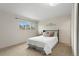 Bright bedroom featuring a bed, window, and closet space at 4212 W Pondview Dr, Littleton, CO 80123
