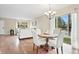 Open concept dining area featuring hardwood floors and slider with backyard views at 4212 W Pondview Dr, Littleton, CO 80123