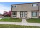 Charming townhome featuring a well-manicured lawn and lovely curb appeal with flowering tree at 4212 W Pondview Dr, Littleton, CO 80123