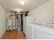Functional laundry room with washer, dryer, water heater, and ample space at 4212 W Pondview Dr, Littleton, CO 80123
