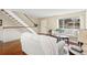 Bright living room featuring hardwood floors, staircase, and backyard views at 4212 W Pondview Dr, Littleton, CO 80123