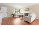 Cozy living room features hardwood floors, large windows, and neutral decor at 4212 W Pondview Dr, Littleton, CO 80123