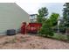 A view of the backyard and red deck area in addition to the adjacent gravel section for additional storage at 2777 S Sedalia St, Aurora, CO 80013