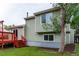 Exterior view of the home showing the backyard, deck and green siding at 2777 S Sedalia St, Aurora, CO 80013