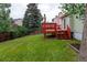 A spacious backyard featuring a well-maintained lawn and a charming red deck, perfect for outdoor relaxation and entertaining at 2777 S Sedalia St, Aurora, CO 80013