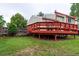 A spacious backyard featuring a well-maintained lawn and a charming red deck, perfect for outdoor relaxation and entertaining at 2777 S Sedalia St, Aurora, CO 80013