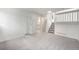 Large basement with neutral carpet, white walls and stairs leading to the main floor at 2777 S Sedalia St, Aurora, CO 80013