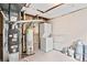 Unfinished basement space with a washer, dryer, water heater and furnace at 2777 S Sedalia St, Aurora, CO 80013